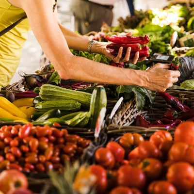 man-choosing-vegetable-from-vegetable-stall-supermarket